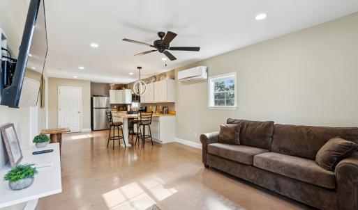 Living area featuring finished concrete floors, re