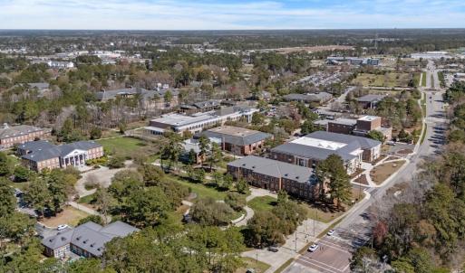 View of property location featuring a tree filled