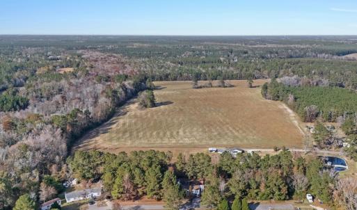 View of property location featuring a forest and r