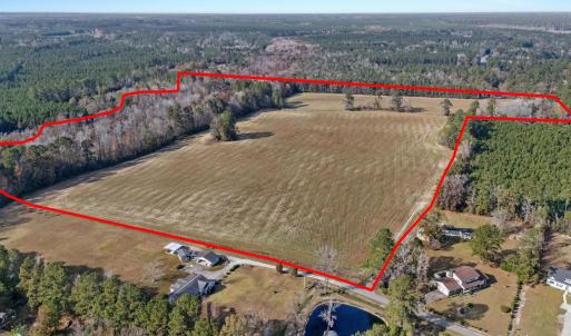 View of property location featuring a forest and p