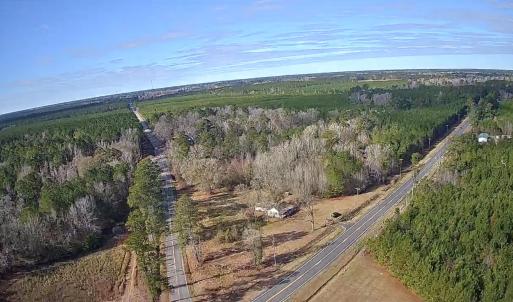 Aerial view of property's location with a forest