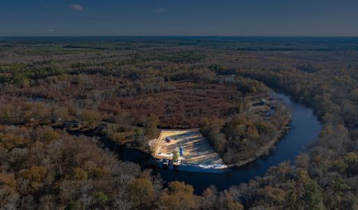 View of property location with a heavily wooded ar