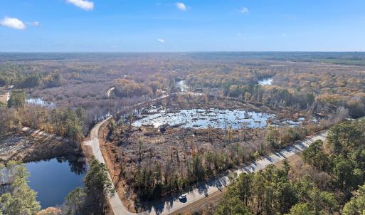 View of property location featuring a forest and a