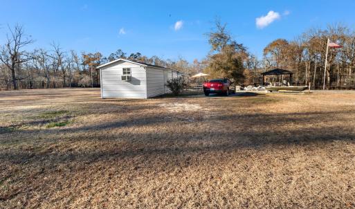 View of the property featuring fencing, a gazebo a