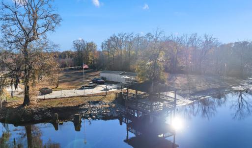 View from the river featuring a gazebo and a boat