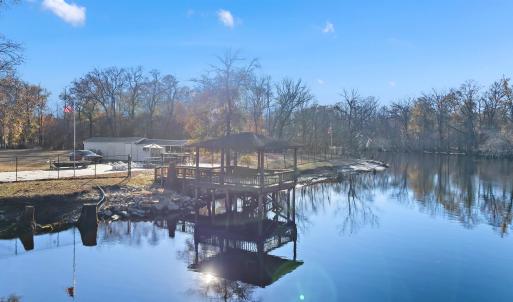 View from the river featuring a gazebo and a boat