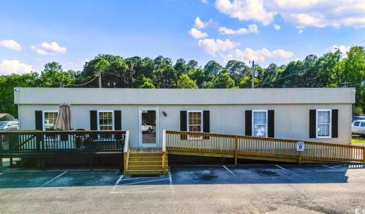 View of property with uncovered parking