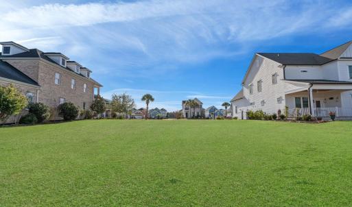 View of grassy yard with a residential view and co