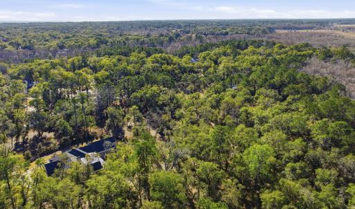 View of property location with a heavily wooded ar
