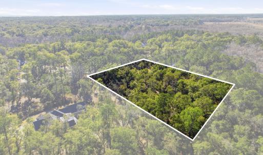 View of property location with a forest and proper