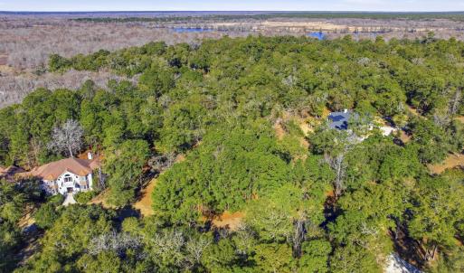 View of property location featuring a forest and a