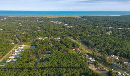 View of property location featuring a forest and a