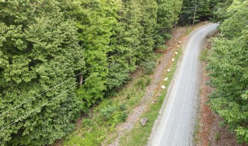 Gravel drive from entrance of the road, passing the lot on the left
