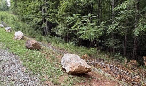 View of landscaping rocks bordering front of lot