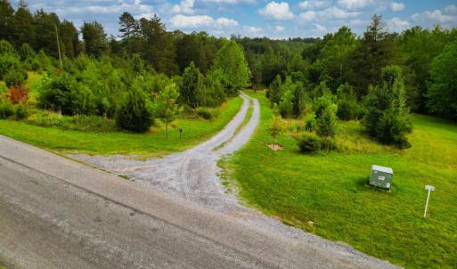 View from Two Bid Road down gravel drive that cuts across the property.