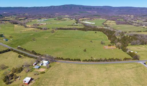 East Point Road frontage looking northwest.  In view is the grazing pasture with pond, and hay pasture just beyond.