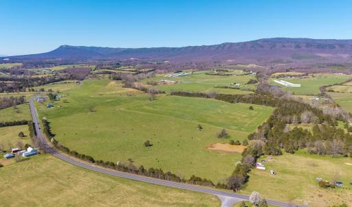Beautiful mountain views from this mostly open parcel of land.  The pond is in view, and the stream is in the forested area that runs left to right across the back 1/3 of the parcel.