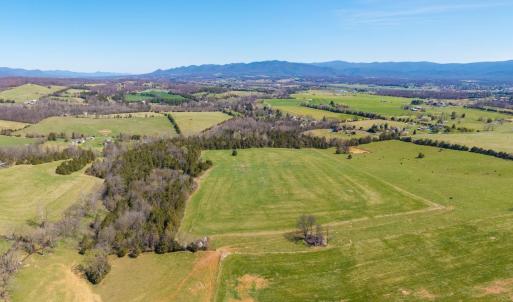 The rear grazing/hay pasture is to the left.  Moving left to right in the picture is the creek and forested ridge, then the front hay pasture, followed by the grazing pasture on the road frontage.