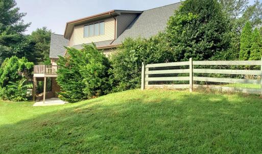 Fenced backyard with garage to right
