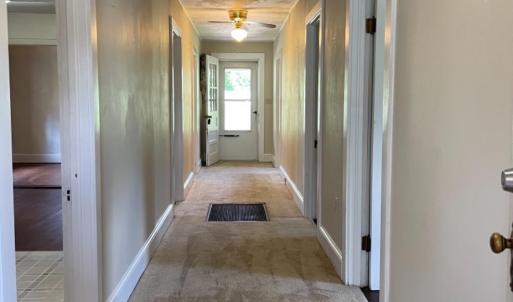 Hallway to bedrooms, sunporch, and laundry room.