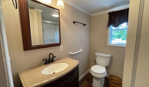 Full updated bath off of kitchen with storage area.