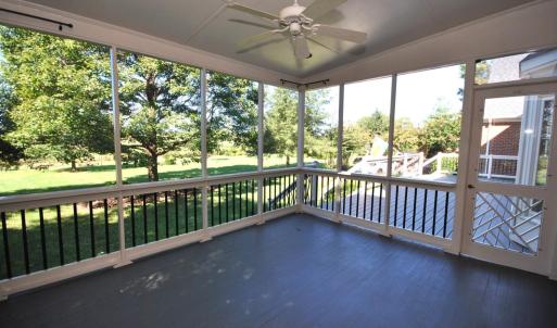 SCREEN PORCH WITH ENTRY TO LARGE DECK - OVERLOOKS BEAUTIFULLY LANDSCAPED YARD