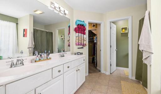 Primary suite bathroom~ separate commode room, shower and bathtub, walk-in closet.