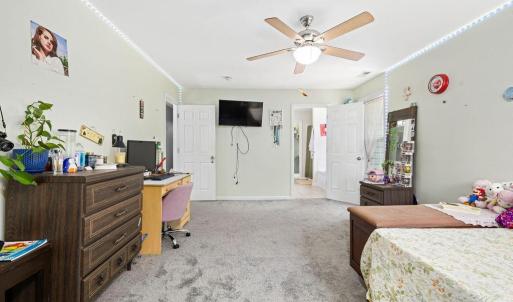 Another shot of the bedroom with the bathroom and closet through the door