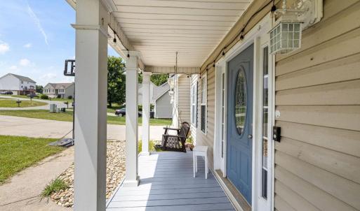 Great front porch to greet neighbors on walks. Fish pond at the end of the porch here.