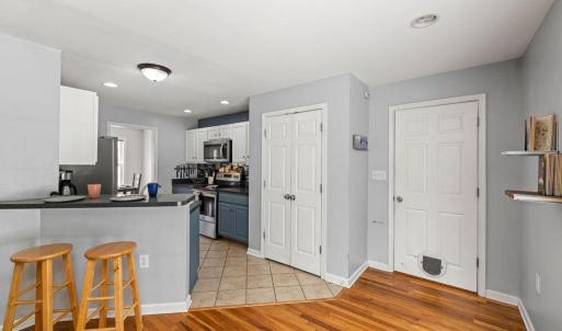 The breakfast bar makes the transition between the LR and kitchen. Pantry is spacious! This is the door to the laundry room.