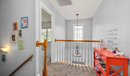 The stairs to go up is on the center wall in the LR; the stairs to go down are stacked under them ~ across from the 1/2 bath. Here we see over the foyer at the front door.