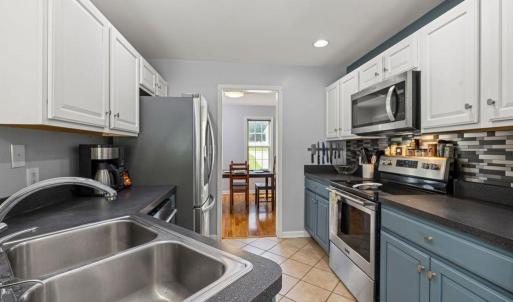The kitchen is compact and has lots of cabinets and counter space.