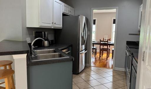 Double kitchen sink is on an angle with workspace between it and the refrigerator. All appliances convey.