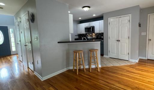 The kitchen island. The 1/2 bath door is the first door on the R on the hallway. The next door on the R is the coat closet. Opposite the bathrooom door is the door to the finished basement.