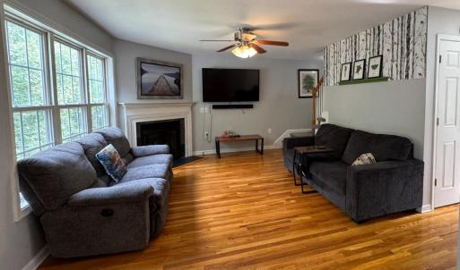 The Living room is at the back of the house with a bank of bright windows. It has a gas fireplace.
