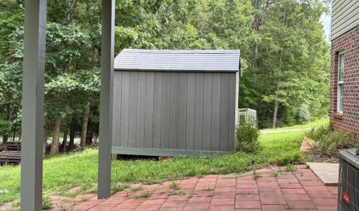 A view of the patio and also a fenced garden spot beyond the shed. Both sheds convey.