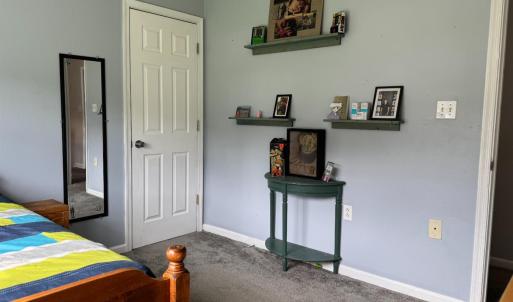 It also has a large closet and shelves on the opposite wall to this closet.
