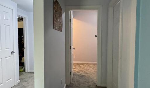 Down the hall on the right is theh 3rd full bathroom! On the other side of this wall is a hallway to the 2 storage rooms.