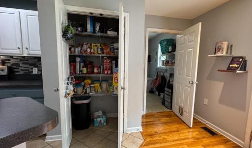 The wonderful large pantry closet! And the door to the laundry room on the right which also leads to the 2-car garage! W/D convey. Seller put lots of shelves in the laundry room, the storage room, the garage.