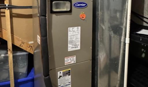 The mechanical room has still more storage space and large shelves! Here is the heat pump (Carrier) which was replaced 5 years ago.