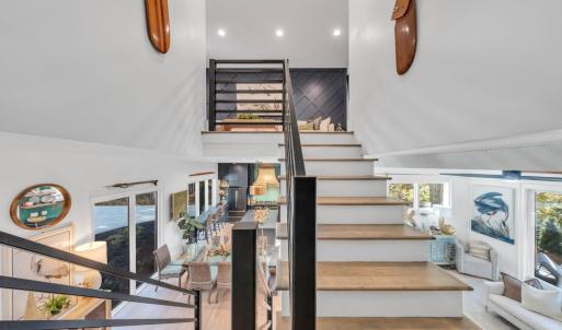 Enter the upper level loft/living room, full bath and 2 additional bedrooms each with access to the upper covered deck overlooking the lake!