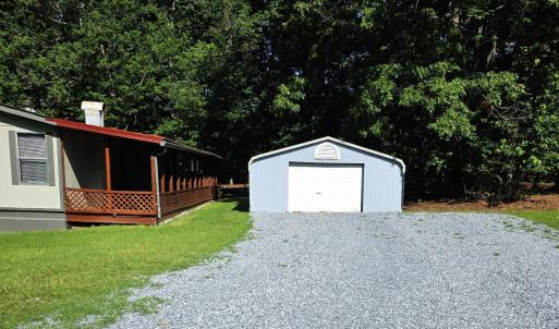 the two car enclosed carport is at the top of the driveway.
