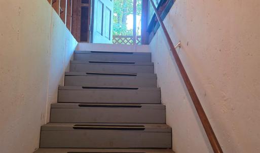 Stairs to the full basement. A rare find with a single-wide manufactured home!