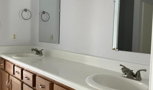 Upstairs bathroom with double sinks and vanity