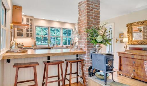 Cozy up with your morning coffee next to the Jøtul “Little Giant” wood stove with glass door.