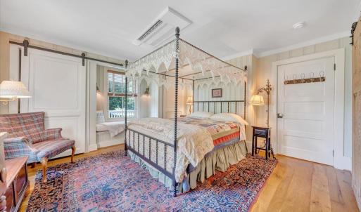 Furniture, lighting, and doors are original to the house, complimented by new closets and a window seat with storage underneath.