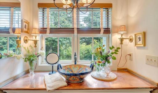 Handmade Mexican salad bowl used as sink.  Copper countertop. Original dresser retrofitted as vanity underneath.