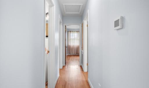 Hallway from living room and kitchen towards bedrooms and bathroom