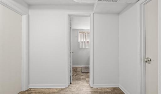 Basement hallway view looking towards bathroom and bedroom