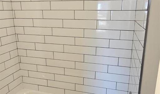 Full hall bath w/ ceramic tile shower walls, tub & granite topped vanity
